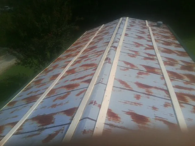 Rusted metal roof panels with new wood purlins before replacement — Storm Damage Roof Repair in Yachats by Roofing Brothers
